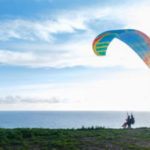 Paragliding instructor prepares to fly up into the sky