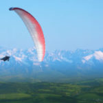 Paraglider in mid-air, Snow Covered Tatra Mountains